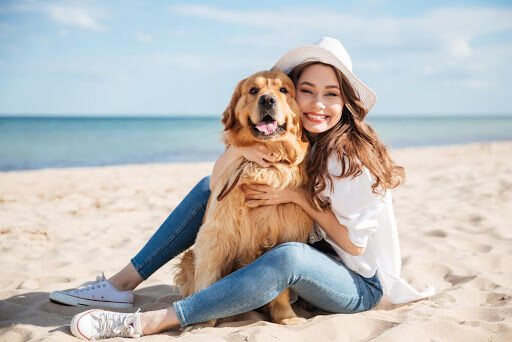 woman with dog on beach